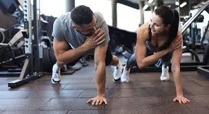 Image of man and woman doing Cardio Herne to tone their arms. 